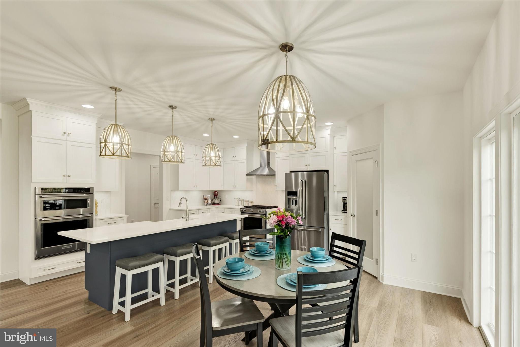 1033 Lititz Bend Drive Lititz, PA 17543 - Photo 23 of 58 a view of a dining room with furniture a chandelier and wooden floor