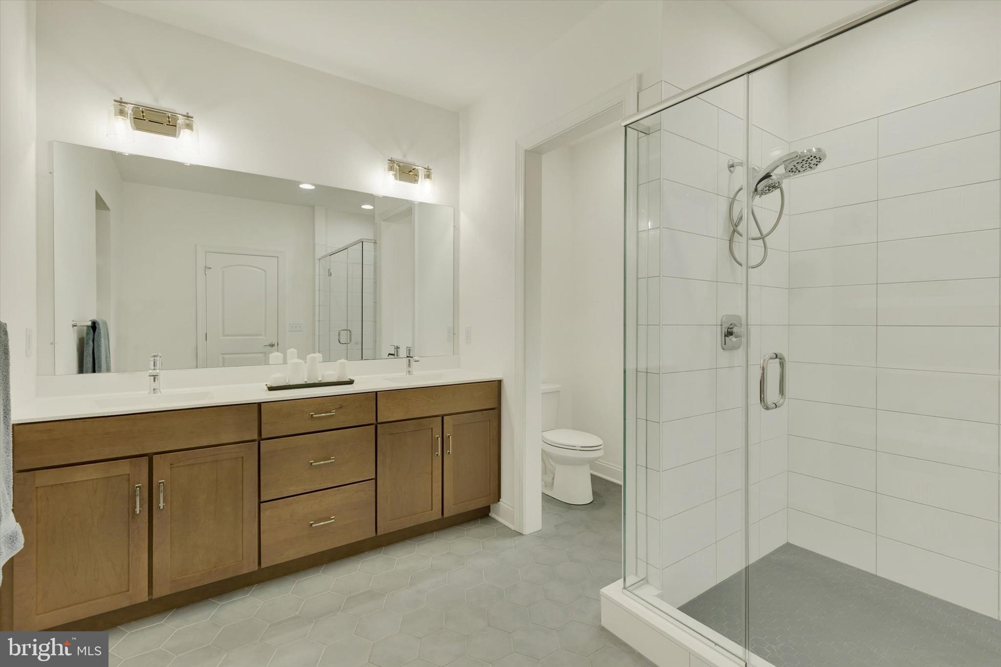1033 Lititz Bend Drive Lititz, PA 17543 - Photo 47 of 58 a bathroom with a double vanity sink mirror and toilet