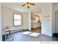 a view of a livingroom with furniture and a window