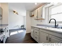 a kitchen with a sink cabinets and a wooden floor