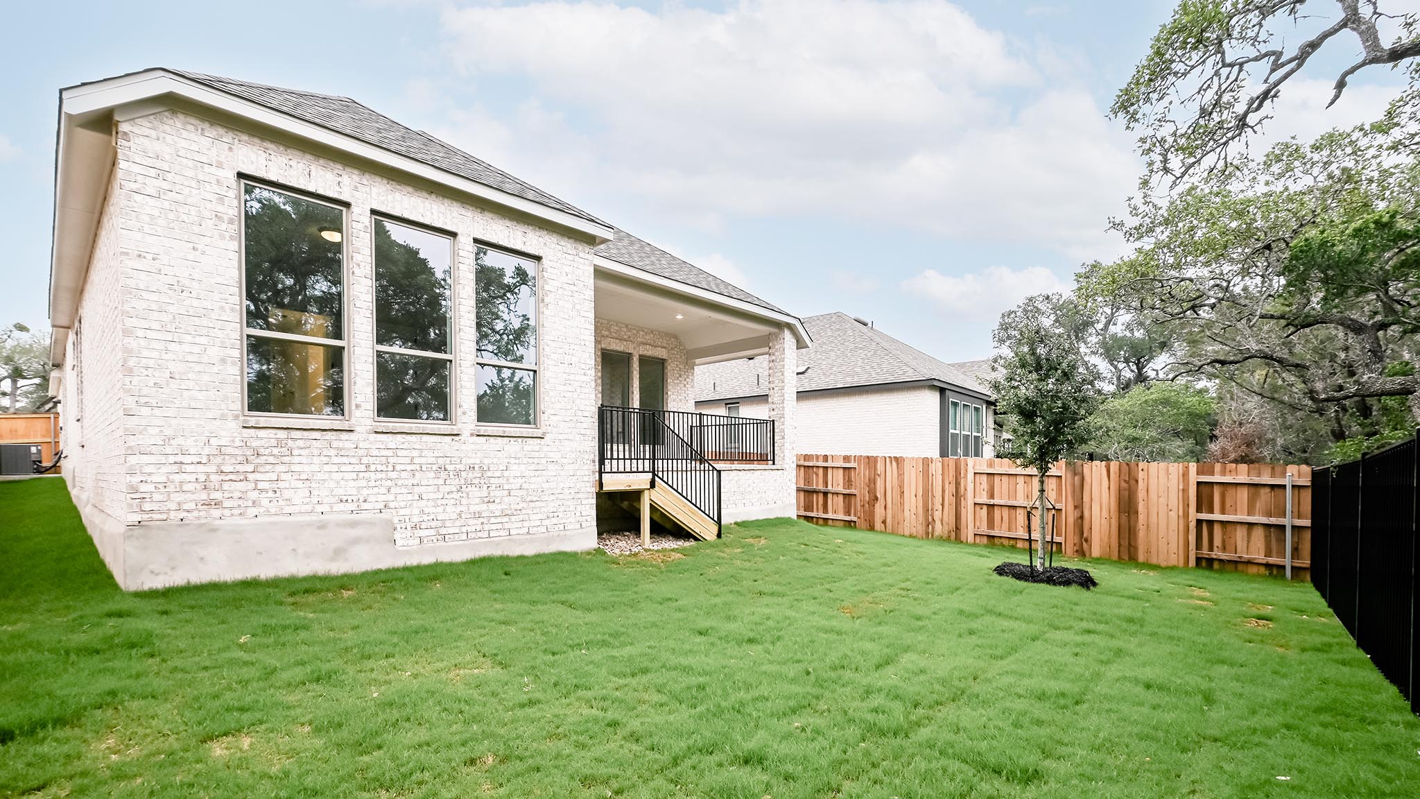 268 Basket Flower Loop Kyle, TX 78640 - Photo 23 of 27 a view of a house with a yard and a large tree