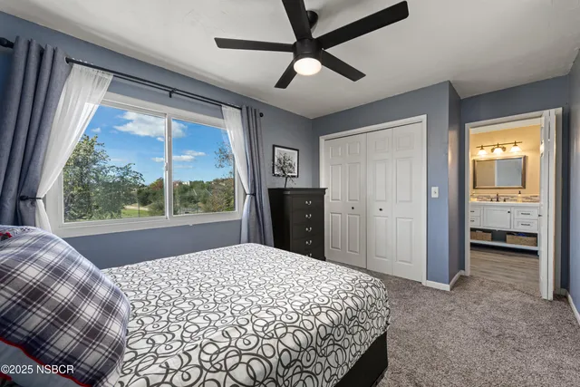 a bedroom with a bed and a large window