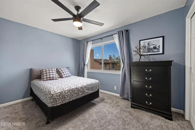 a bedroom with a bed a window and a dresser