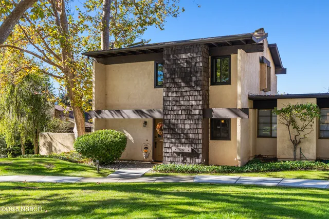a front view of a house with garden