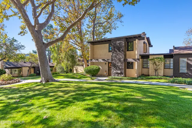 a house view with a sitting space and garden