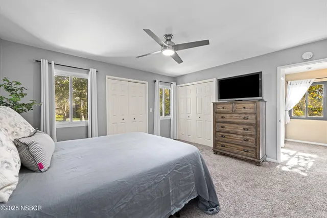 a bedroom with a bed and a television