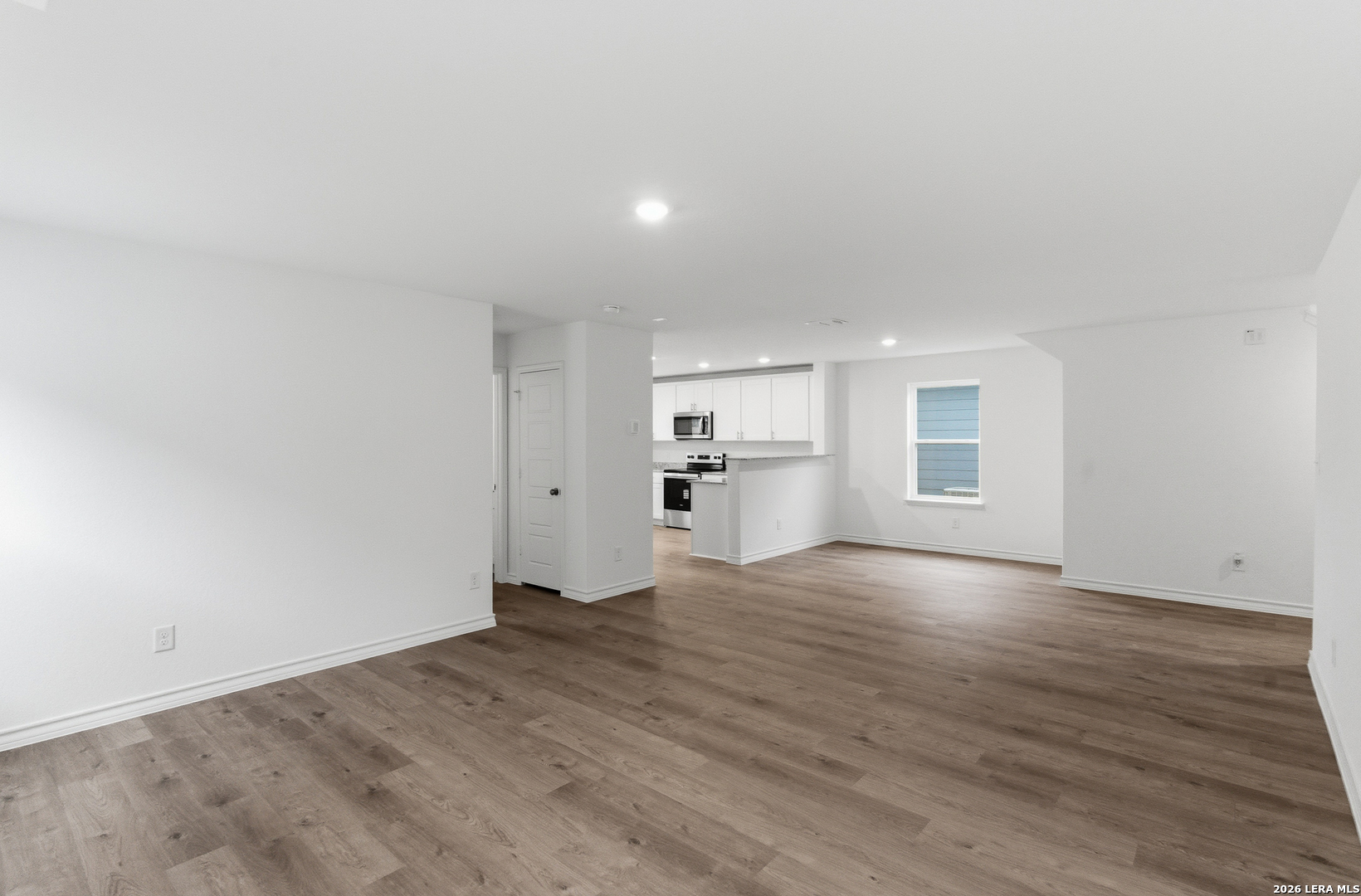 4142 Bermuda Lane Seguin, TX 78155 - Photo 6 of 30 a view of empty room with wooden floor and kitchen