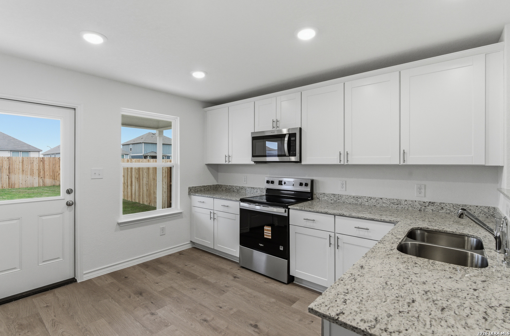 4142 Bermuda Lane Seguin, TX 78155 - Photo 7 of 30 a kitchen with granite countertop white cabinets and stainless steel appliances