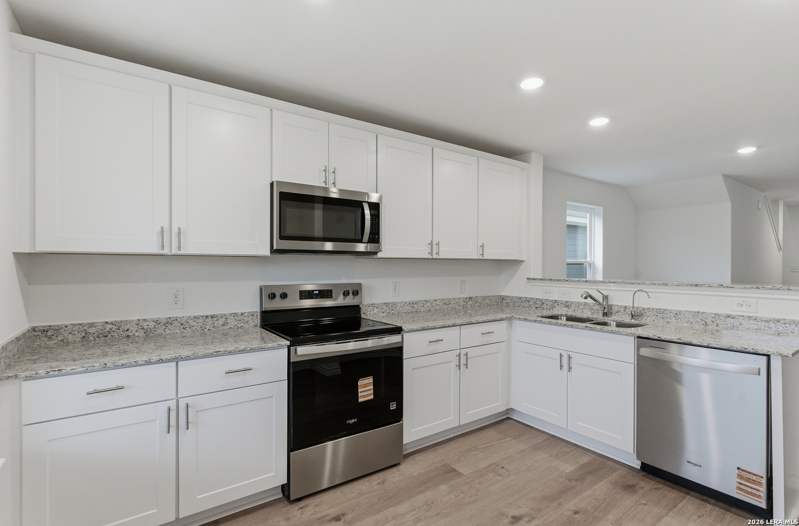 4142 Bermuda Lane Seguin, TX 78155 - Photo 8 of 30 a kitchen with granite countertop white cabinets sink and stainless steel appliances