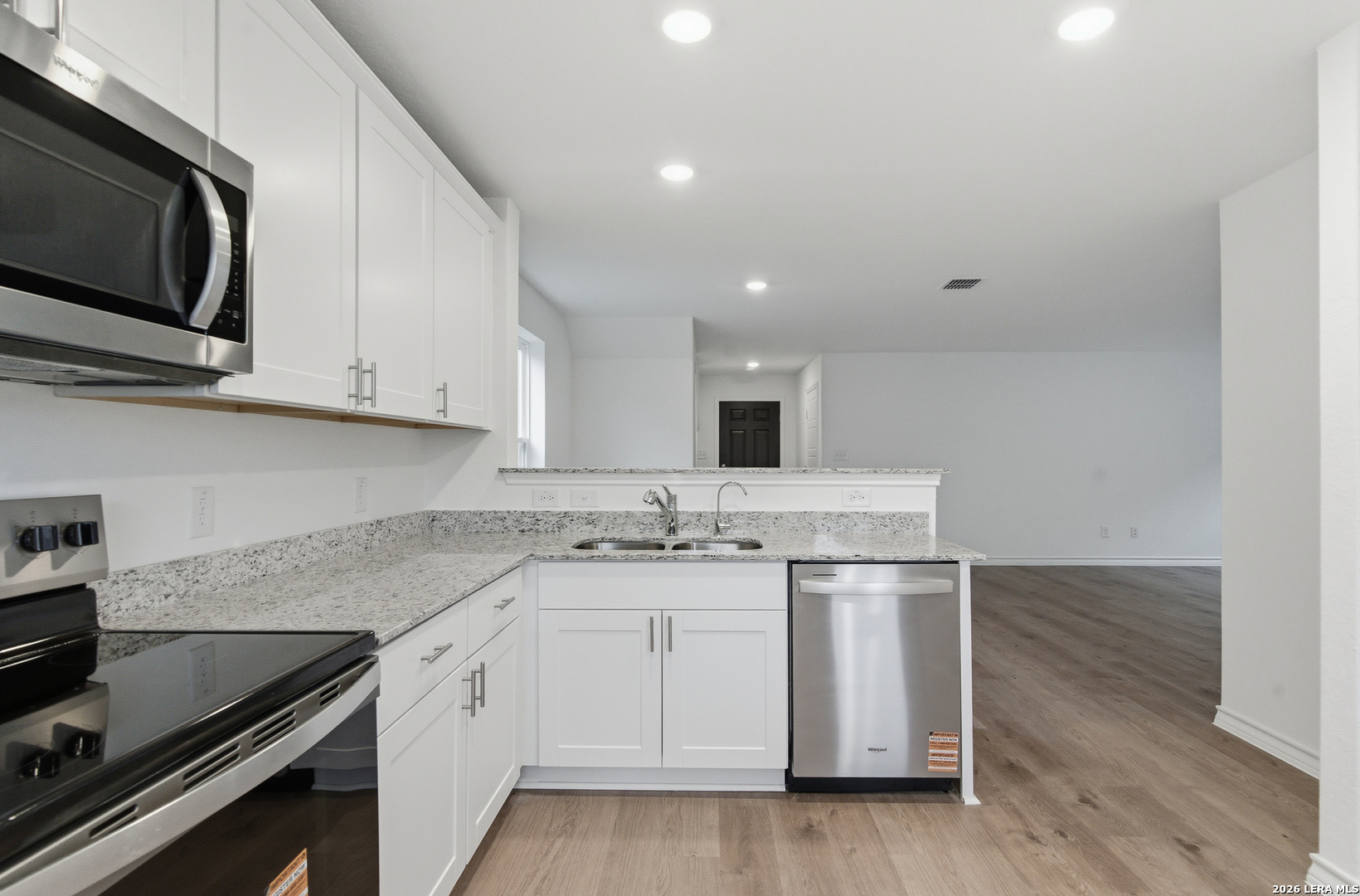 4142 Bermuda Lane Seguin, TX 78155 - Photo 9 of 30 a kitchen with stainless steel appliances granite countertop a sink and a stove top oven