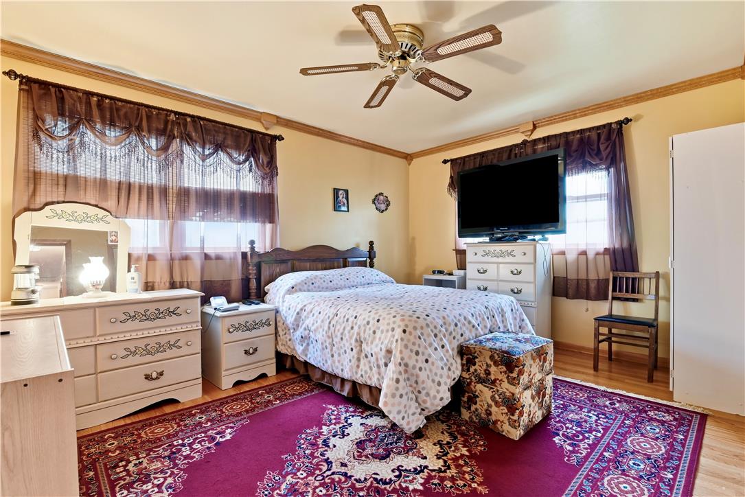 3303 Barklay Road Whitehall, PA 18052 - Photo 21 of 31 A comforting bedroom features warm walls, rich wood flooring, and a decorative ceiling fan, creating a welcoming atmosphere.