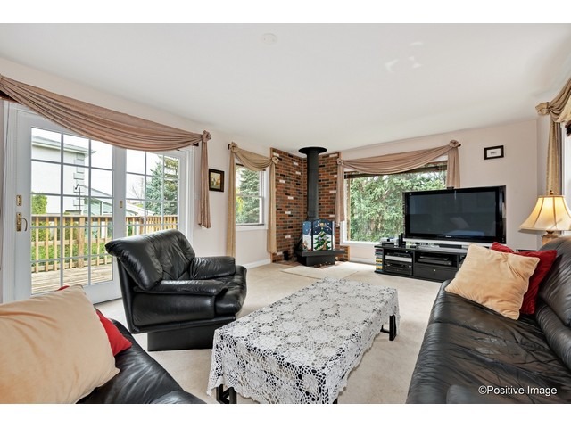 1019 North Delphia Avenue Park Ridge, IL 60068 - Photo 11 of 25 a living room with furniture and a flat screen tv