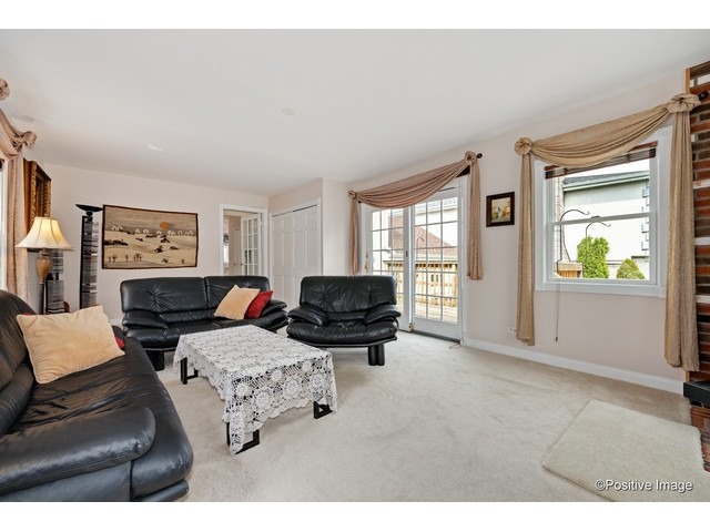 1019 North Delphia Avenue Park Ridge, IL 60068 - Photo 12 of 25 a living room with furniture and a flat screen tv