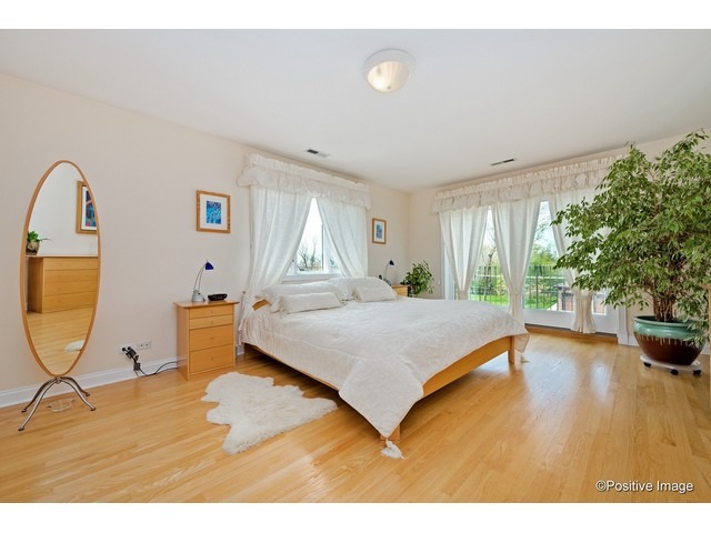 1019 North Delphia Avenue Park Ridge, IL 60068 - Photo 15 of 25 a bedroom with a bed and a chandelier