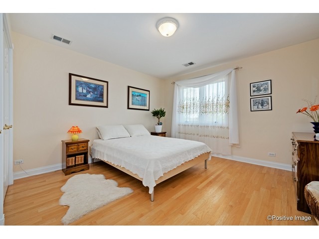 1019 North Delphia Avenue Park Ridge, IL 60068 - Photo 18 of 25 a bedroom with a bed and a dresser with rug