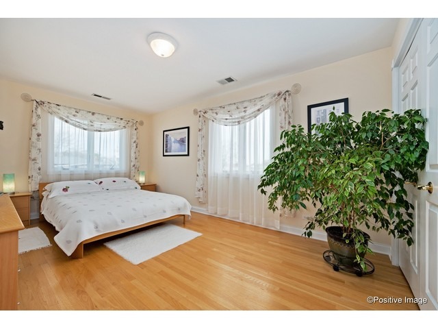 1019 North Delphia Avenue Park Ridge, IL 60068 - Photo 19 of 25 a bedroom with a bed windows and a potted plant