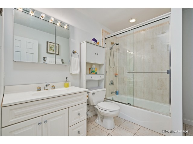 1019 North Delphia Avenue Park Ridge, IL 60068 - Photo 20 of 25 a bathroom with a sink toilet a mirror and shower