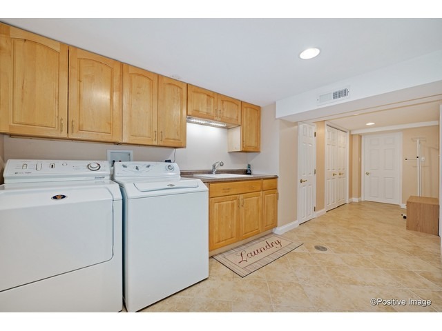 1019 North Delphia Avenue Park Ridge, IL 60068 - Photo 22 of 25 a utility room with cabinets washer and dryer