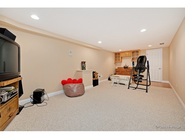 1019 North Delphia Avenue Park Ridge, IL 60068 - Photo 23 of 25 a living room with furniture and a flat screen tv