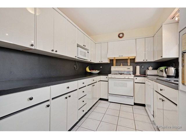 1019 North Delphia Avenue Park Ridge, IL 60068 - Photo 7 of 25 a kitchen with granite countertop white cabinets and white appliances