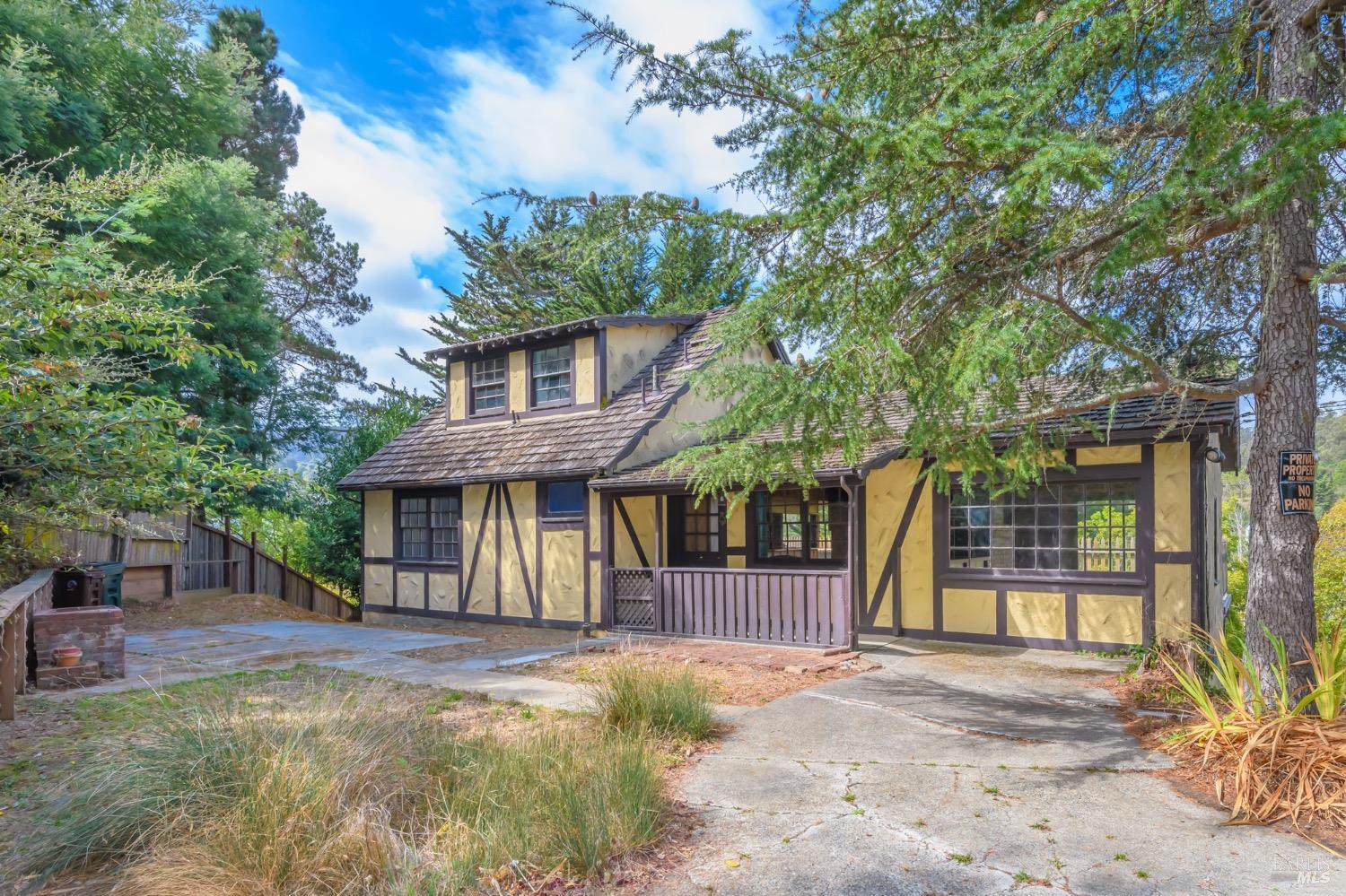 a view of a white house with a large windows and large trees