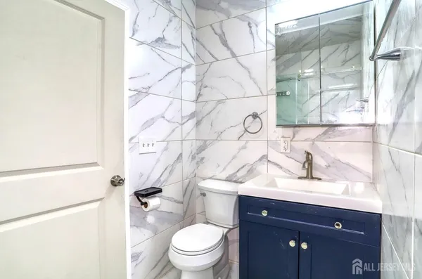 a bathroom with a sink toilet vanity and shower