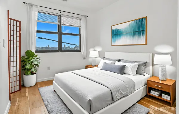 a bedroom with a bed and a painting on the wall