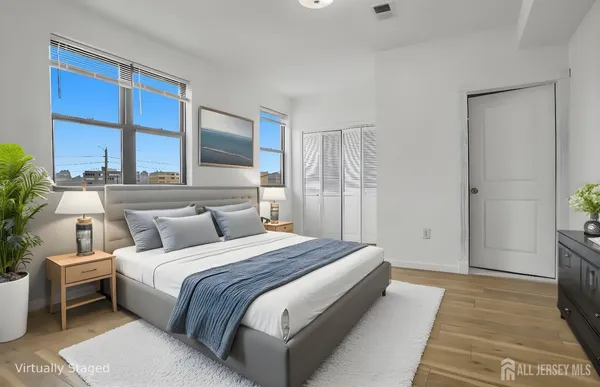 a bedroom with a bed and a large window