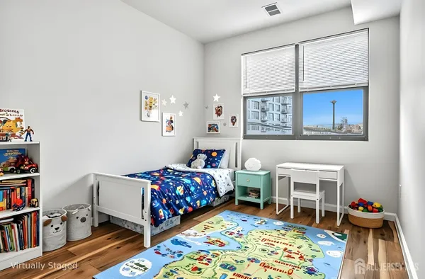 a bedroom with bed and a book shelf