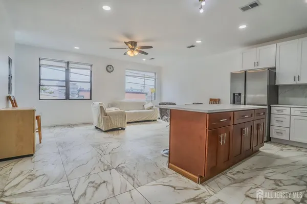 a kitchen with stainless steel appliances granite countertop a sink counter space cabinets and a window