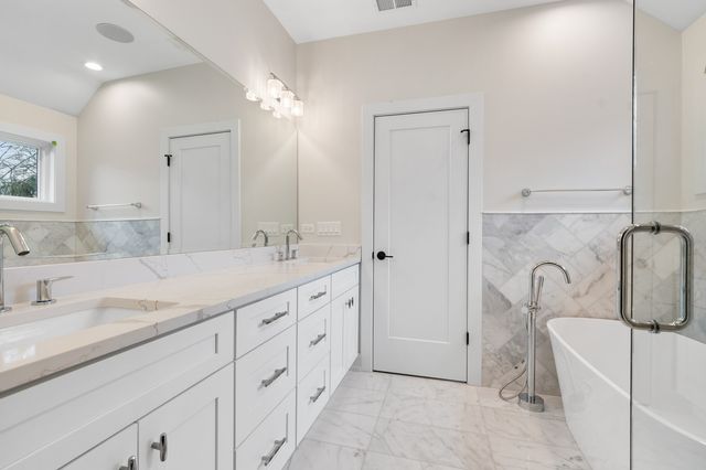 a spacious bathroom with a granite countertop sink a toilet and shower
