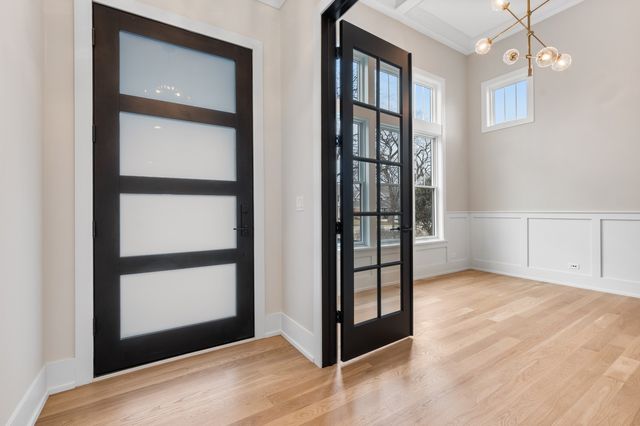 an empty room with windows and entrance