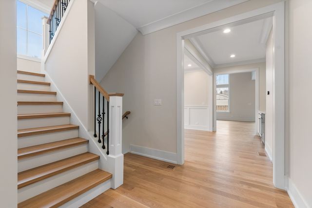 a view of a hallway with wooden floor and entryway
