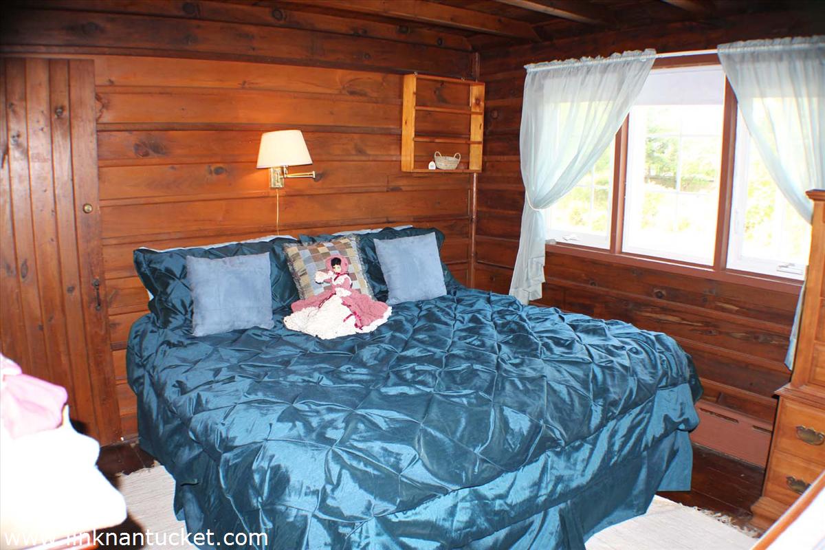 47 A Fairgrounds Road Nantucket, MA 02554 - Photo 7 of 9 a bed sitting in a bedroom next to a window