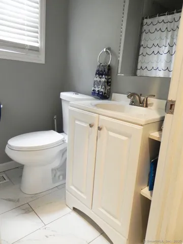 a bathroom with a toilet and a sink