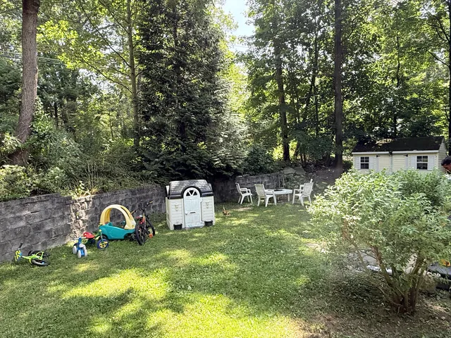 a view of a patio with table and chairs and wooden floor