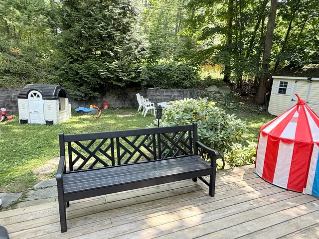 a view of a house with a yard and sitting area