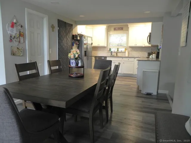 a dining room with furniture and window