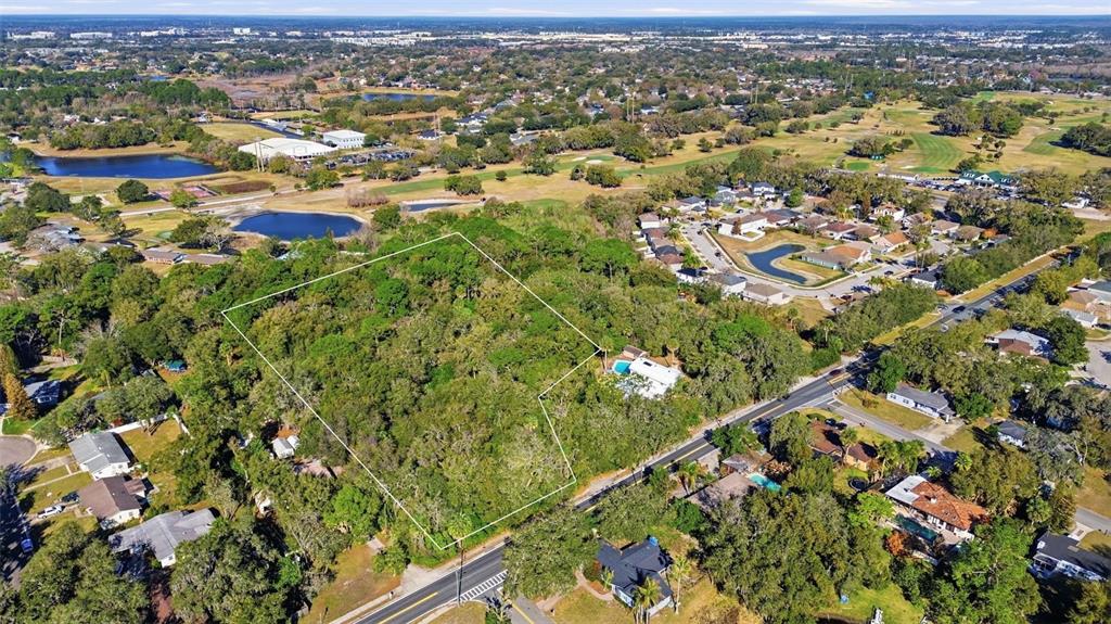 932 Country Club Road Lake Mary, FL 32746 - Photo 2 of 31 an aerial view of residential houses with city and green space