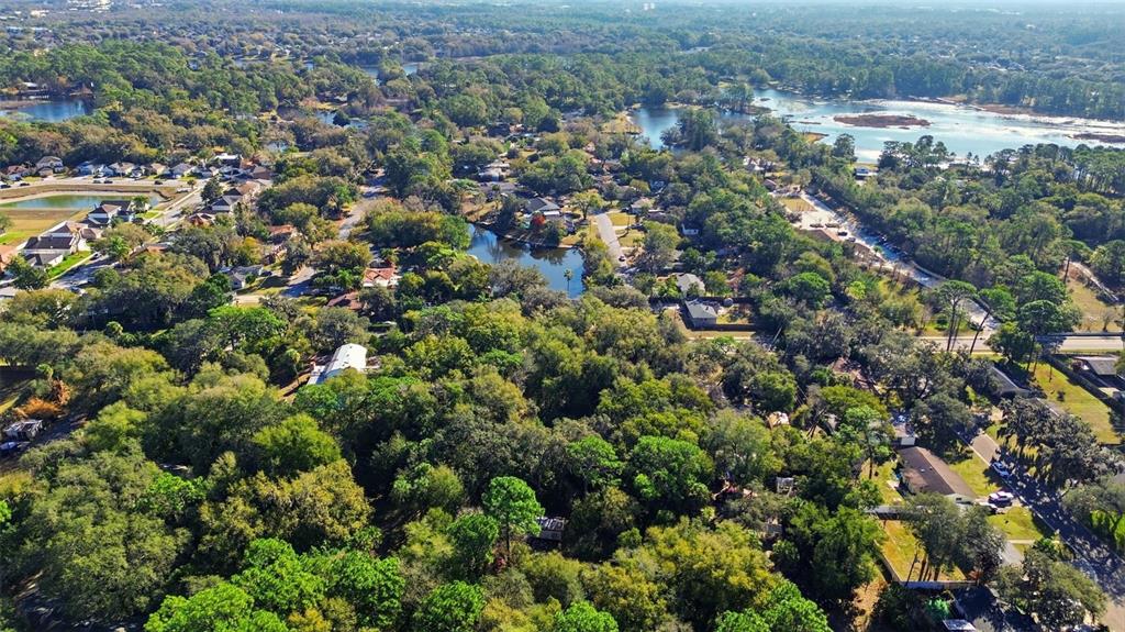 932 Country Club Road Lake Mary, FL 32746 - Photo 3 of 31 an aerial view of residential houses with outdoor space and trees