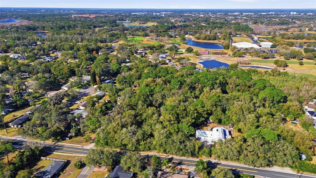 932 Country Club Road Lake Mary, FL 32746 - Photo 6 of 31 an aerial view of residential houses with outdoor space and trees