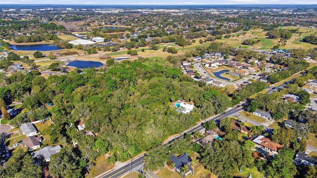 932 Country Club Road Lake Mary, FL 32746 - Photo 10 of 31 an aerial view of residential houses with outdoor space and trees