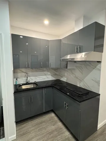 a kitchen with stainless steel appliances granite countertop a sink and a stove