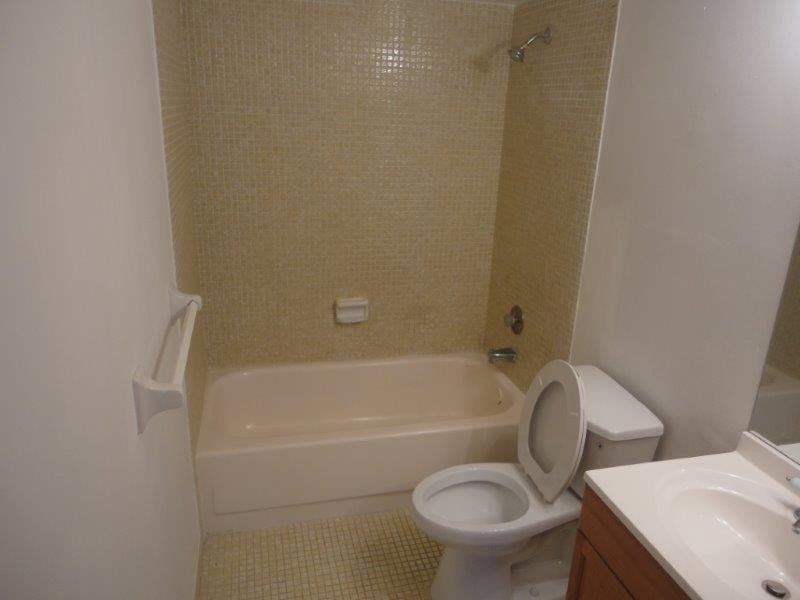 4166 Inverrary Drive, Unit 307 Lauderhill, FL 33319 - Photo 11 of 17 a white toilet sitting next to a bath tub