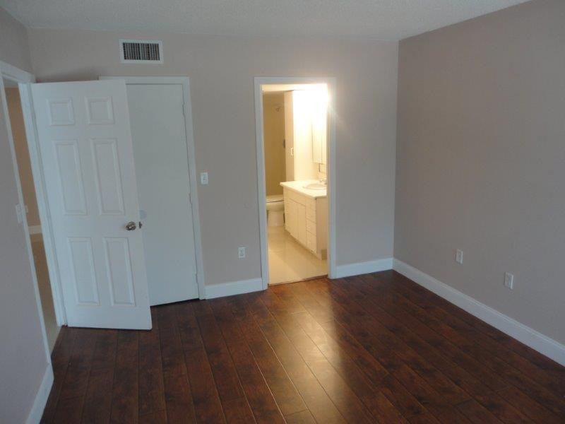 4166 Inverrary Drive, Unit 307 Lauderhill, FL 33319 - Photo 17 of 17 a view of an empty room with wooden floor and a window