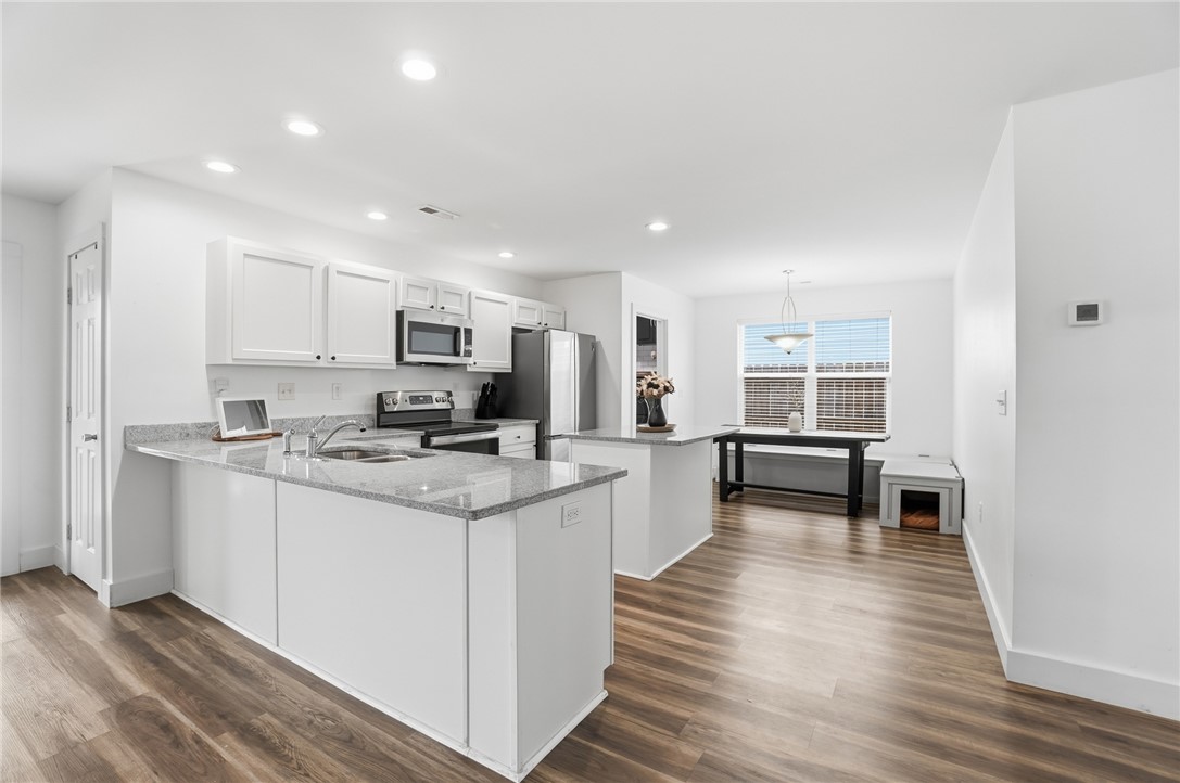 728 East Northern Avenue Springfield, OH 45503 - Photo 9 of 35 Bright and open-concept kitchen features sleek appliances, granite countertops, and ample space for dining.