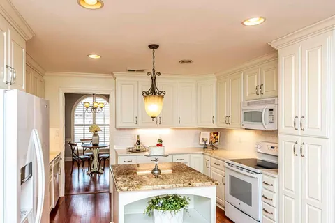 a kitchen with a stove a sink and a refrigerator