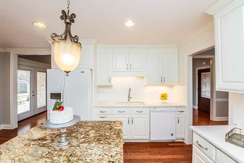 a open kitchen with sink and cabinets