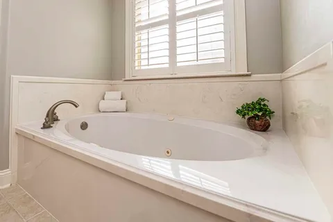 a bathroom with a bathtub and a window