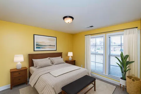 a bedroom with a bed and a window